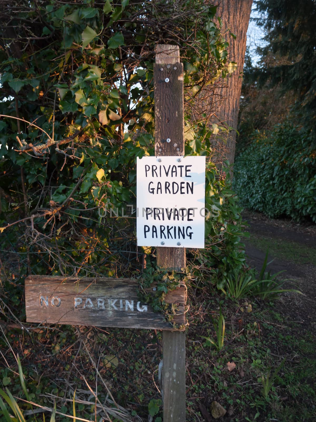 black and white private garden private parking sign; essex; england; uk
