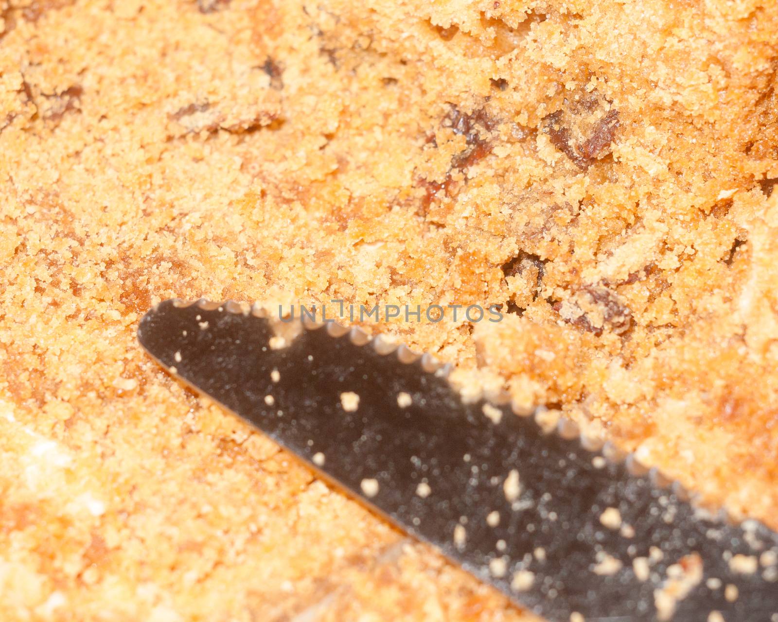 close up of brown sponge cake texture with knife; essex; england; uk