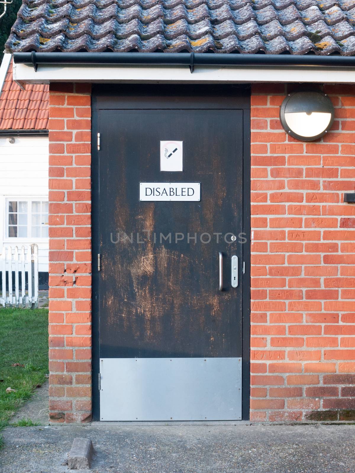 disabled black toilet door outside public park; essex; england; uk