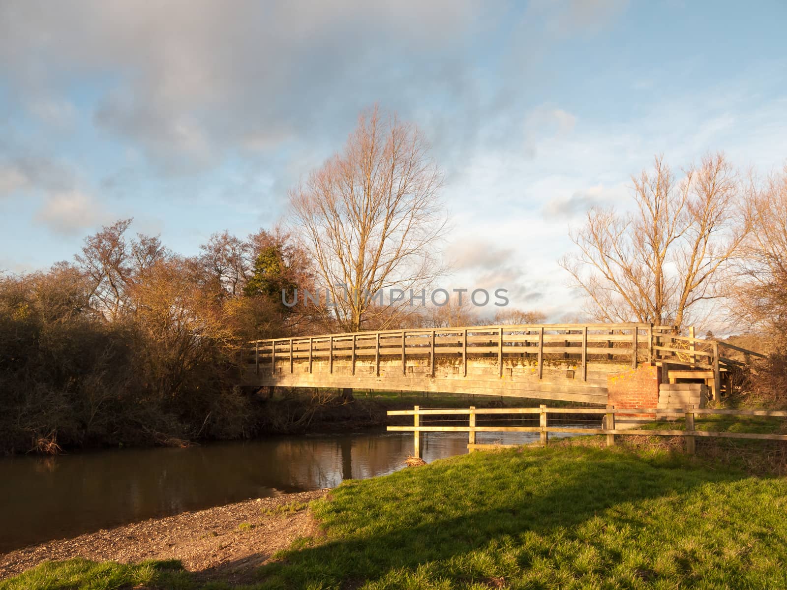 old wooden walking bridge over water sunset landscape by callumrc