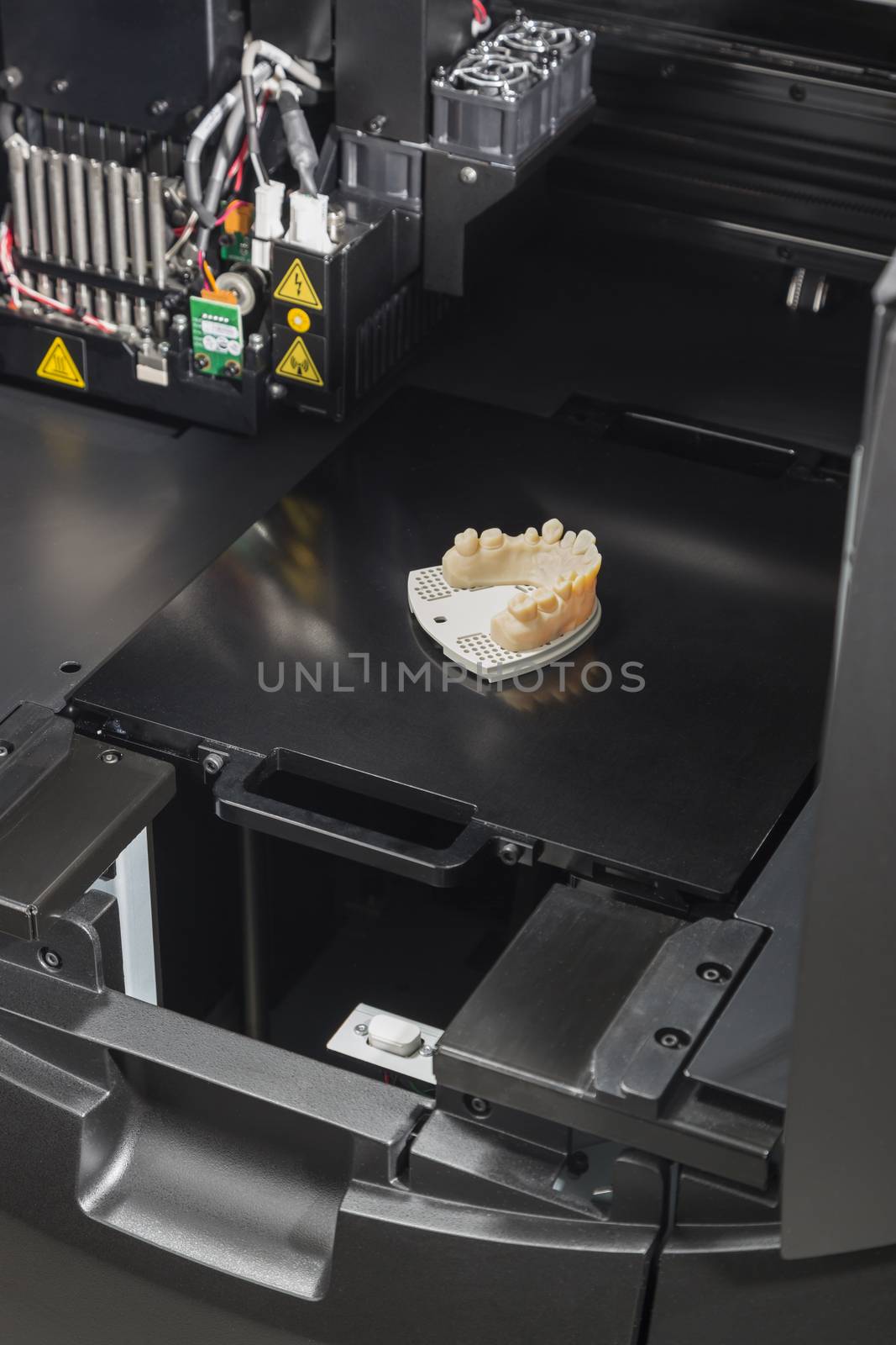 Open 3D Printer With Finished 3D Printed Dental Implant Bridge.