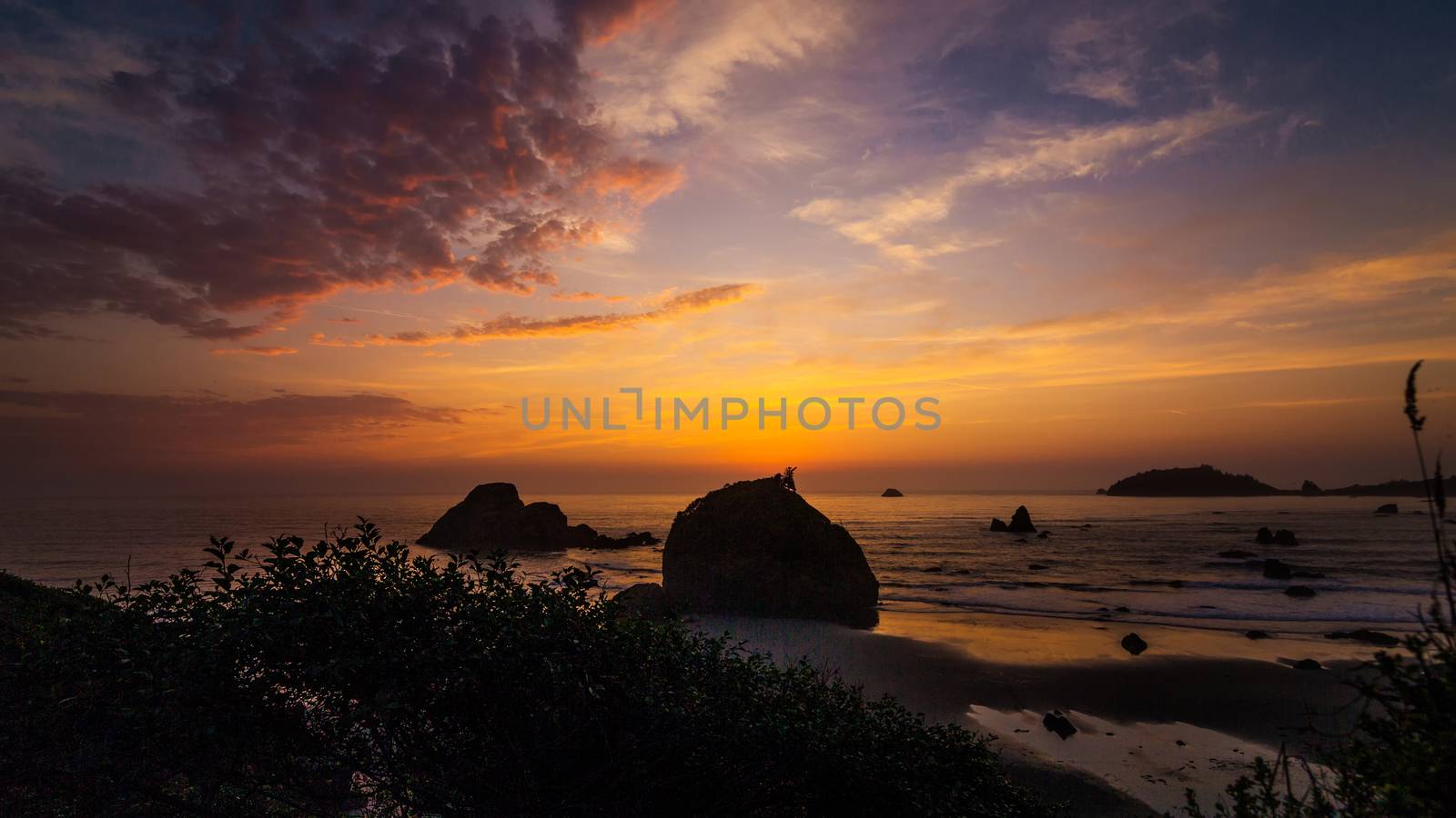 This is a color landscape photo of a vivid sunset over the Pacific Ocean.