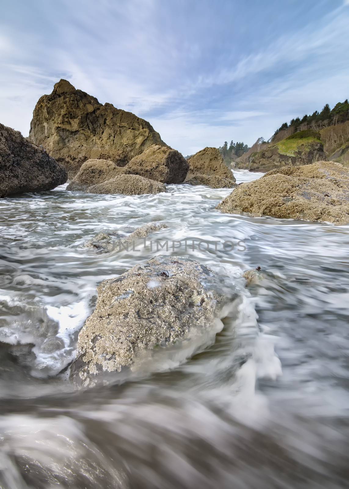 This is a color landscape photo of the Pacific Ocean at a rocky beach.