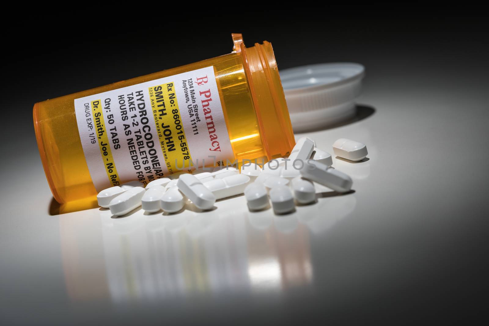 Hydrocodone Pills and Prescription Bottle with Non Proprietary Label. No model release required - contains ficticious information.