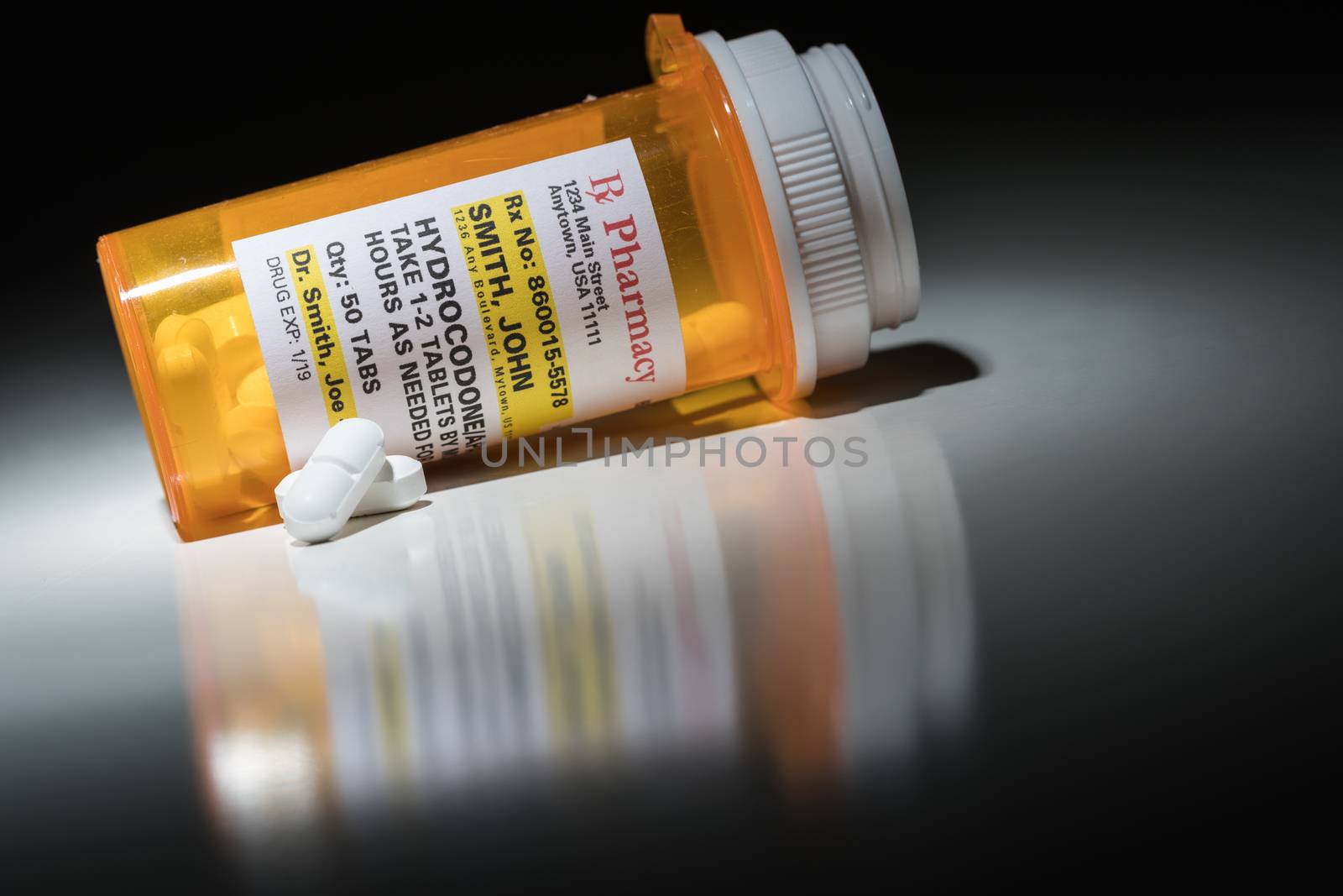 Hydrocodone Pills and Prescription Bottle with Non Proprietary Label. No model release required - contains ficticious information.