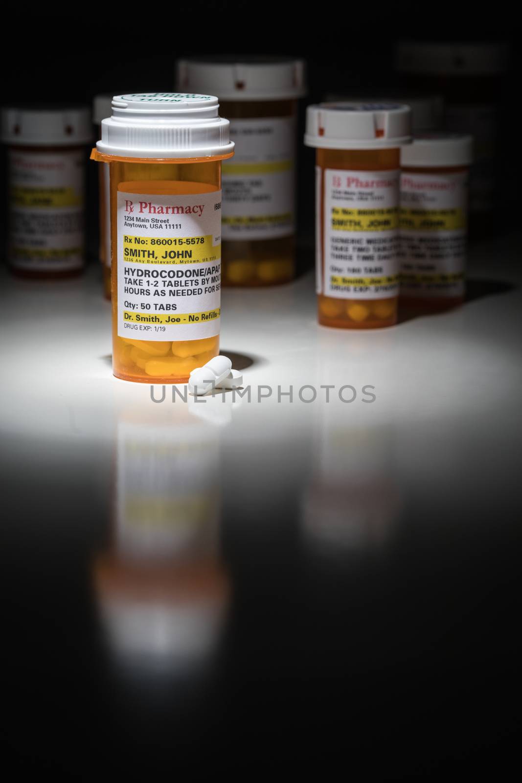 Hydrocodone Pills and Prescription Bottles with Non Proprietary Label. No model release required - contains ficticious information.
