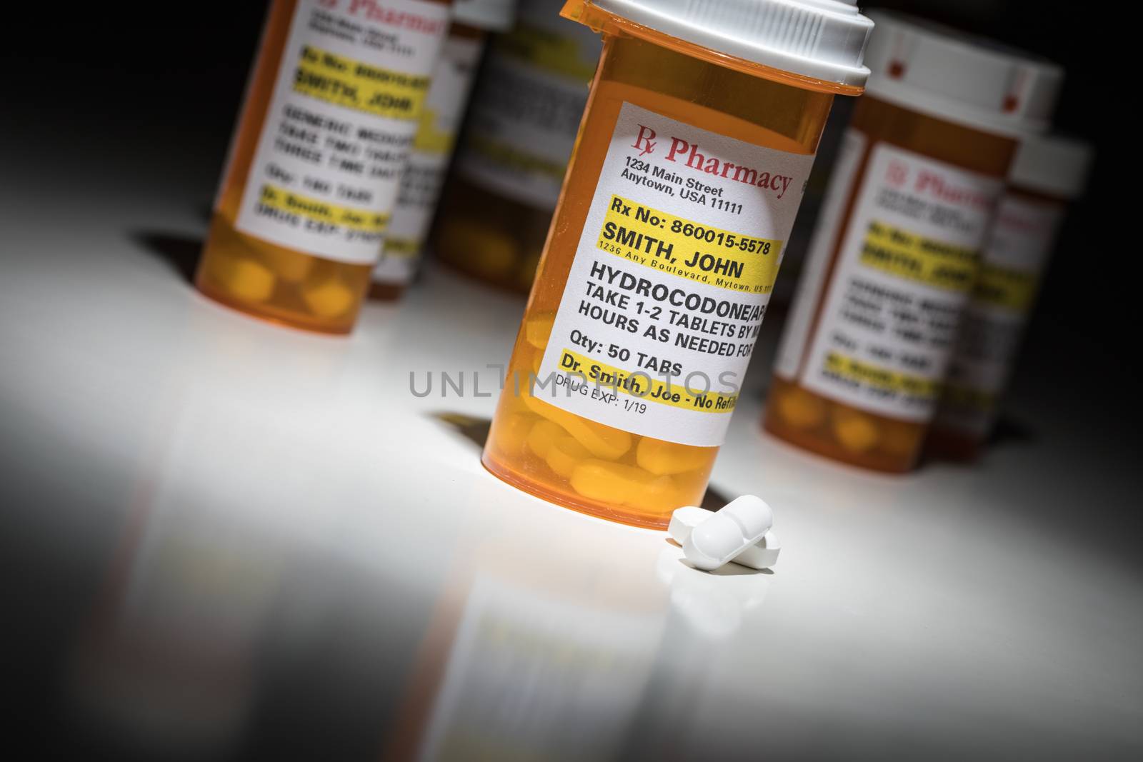 Hydrocodone Pills and Prescription Bottles with Non Proprietary Label. No model release required - contains ficticious information.