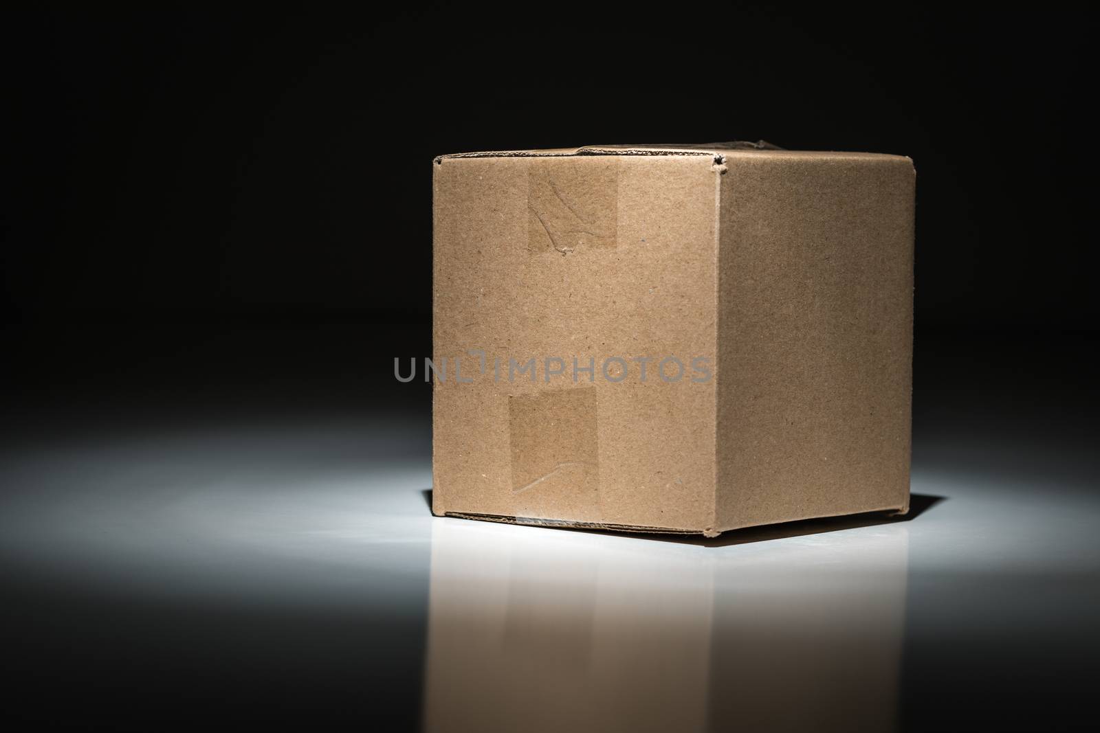 Blank Carboard Shipping Box Under Spot Light.