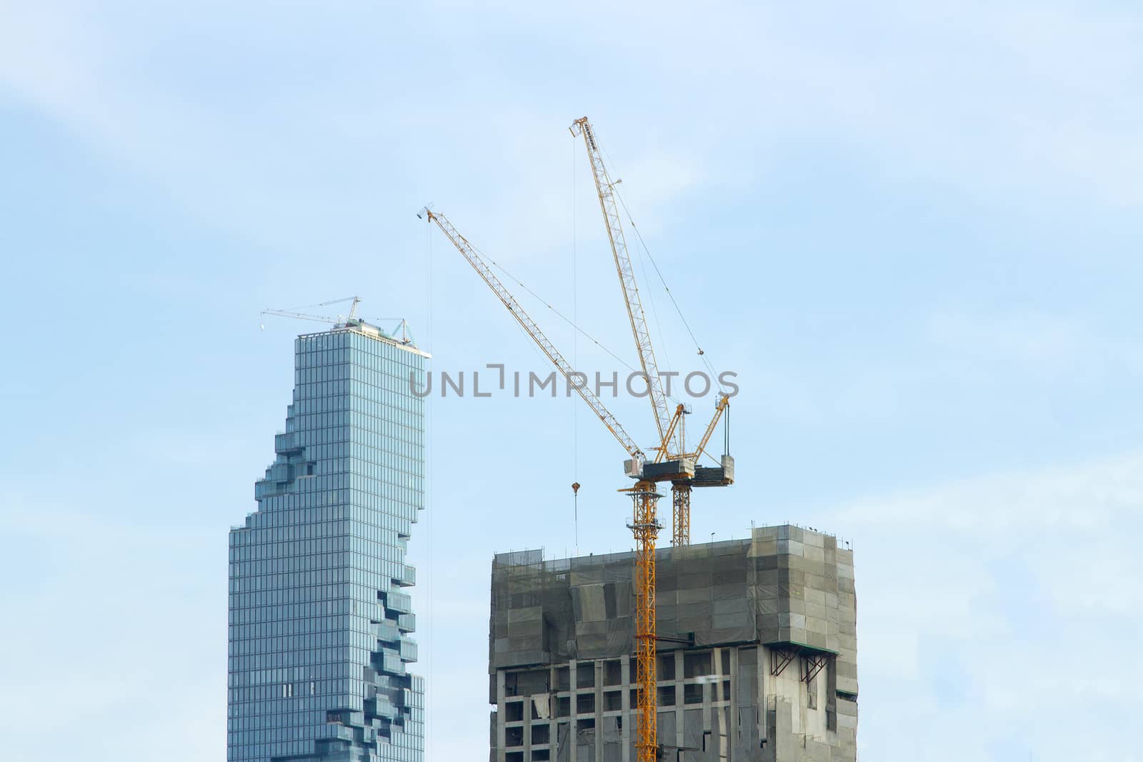 JAN 2017,  Sathorn junction, Bangkok, Thailand : Mahanakhon building view form Expressway Silom with cranes and blue sky