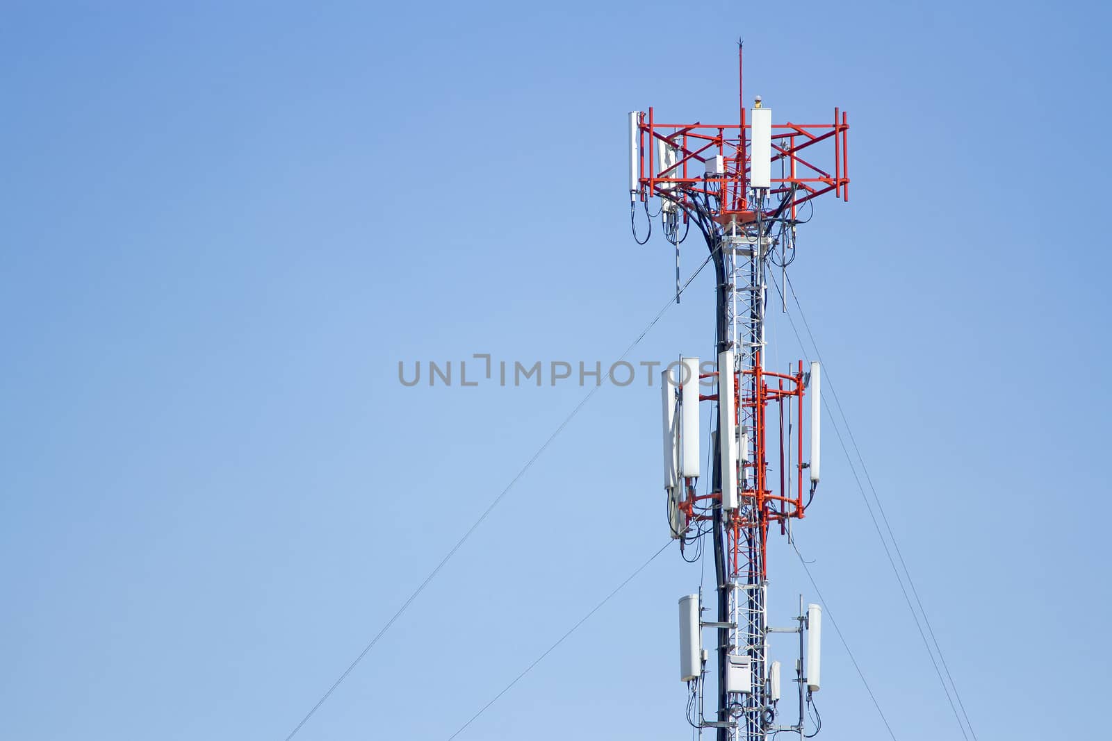Mobile phone communication tower transmission  signal with blue sky background and leash