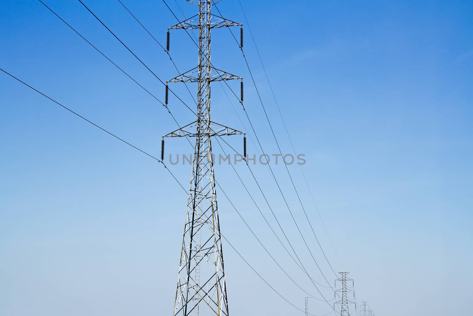 High voltage electric pole with blue sky and engineering background