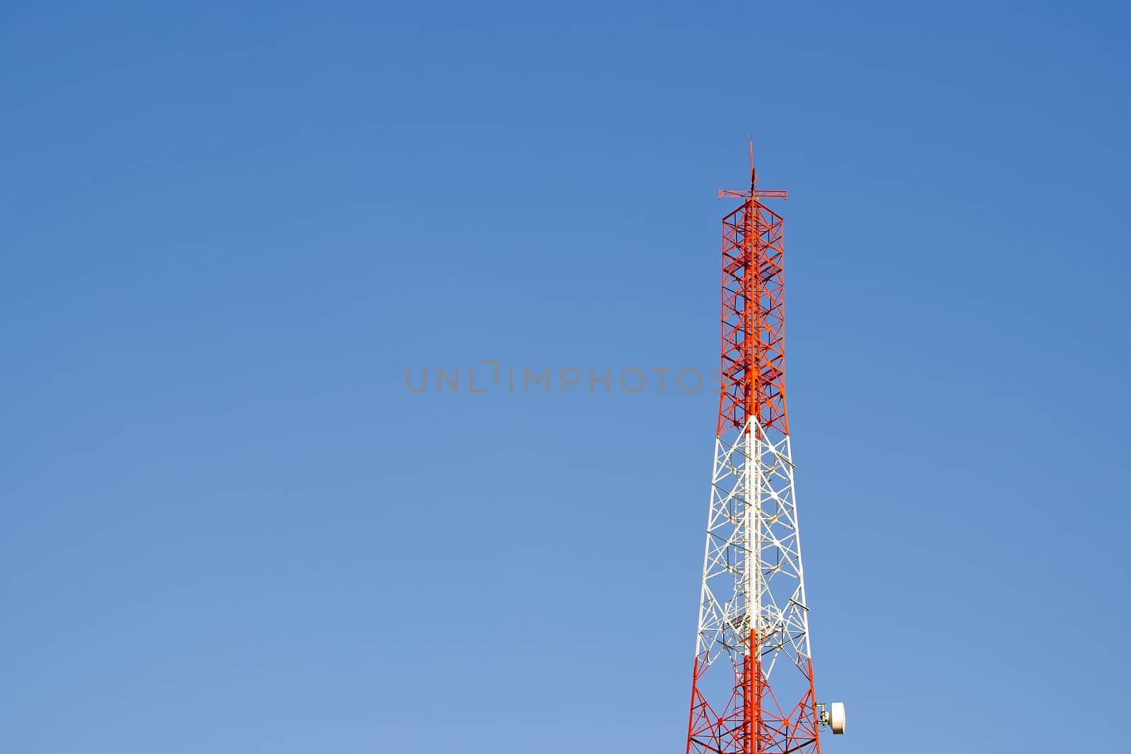 Mobile phone communication tower transmission  signal with blue sky background and antenna