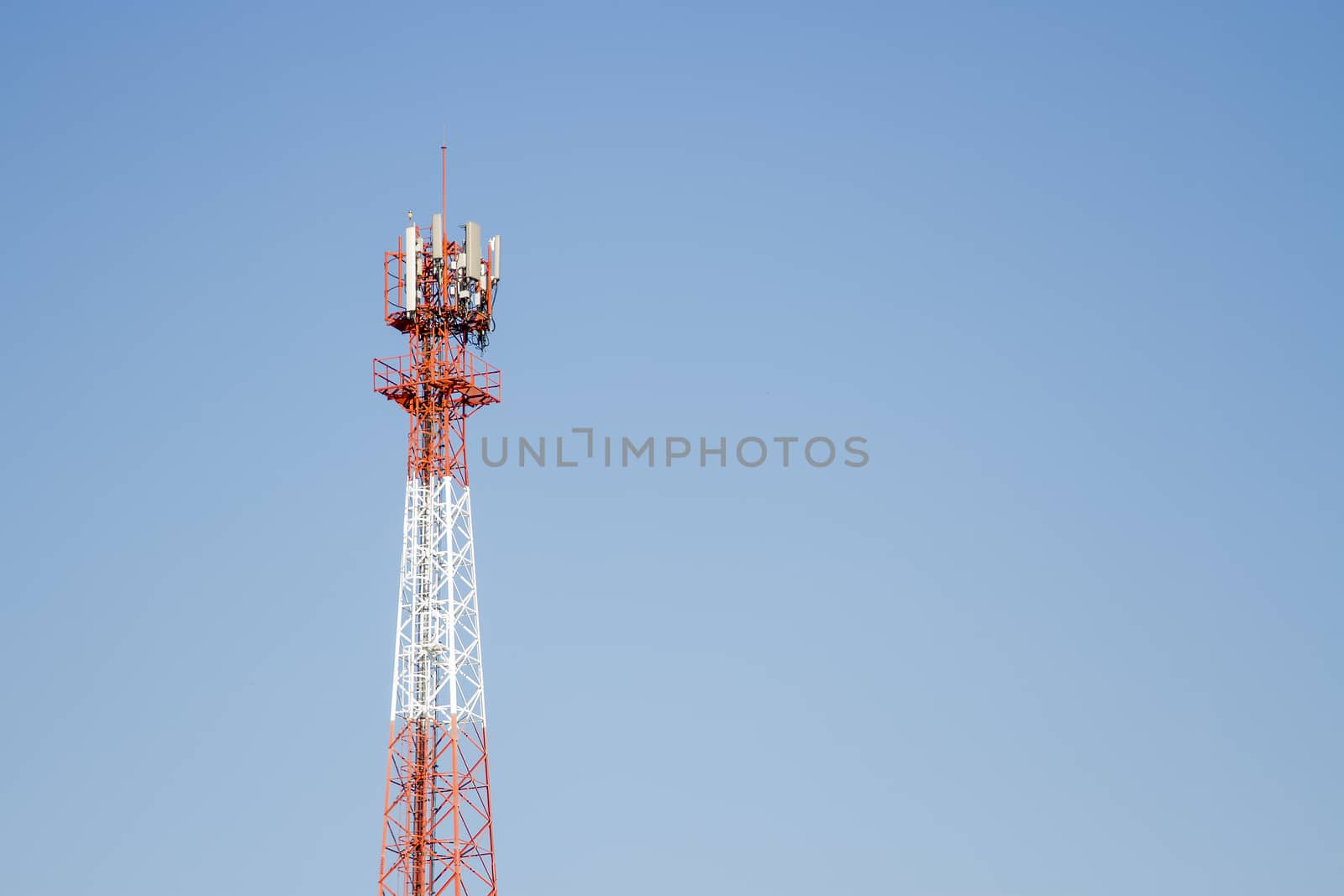 Mobile phone communication tower transmission  signal with blue sky background and antenna