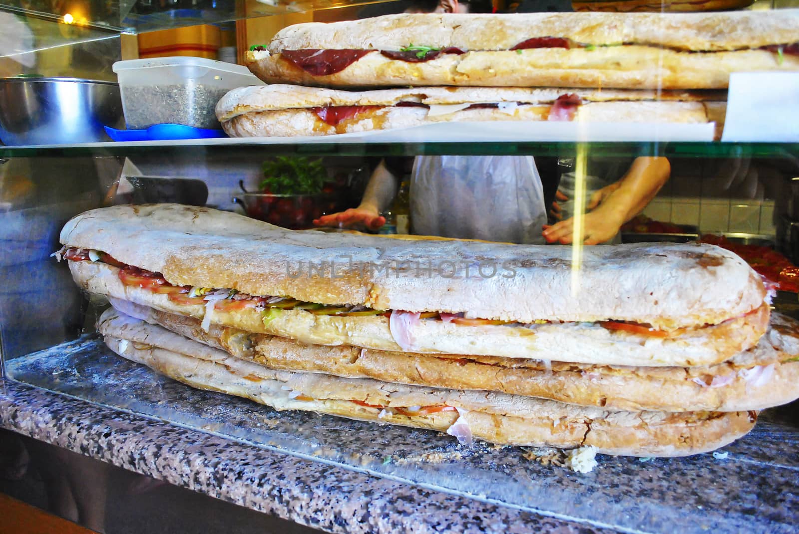 close-up view of a huge stuffed sandwich on a marble floor