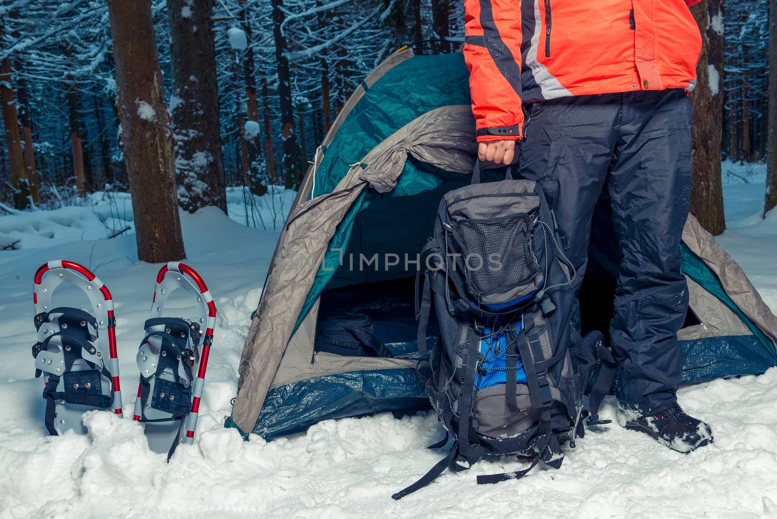 camping in the winter forest, a man with a backpack