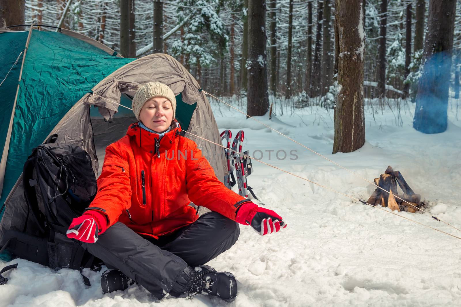 single trekking in the winter forest, girl doing yoga outdoors by kosmsos111
