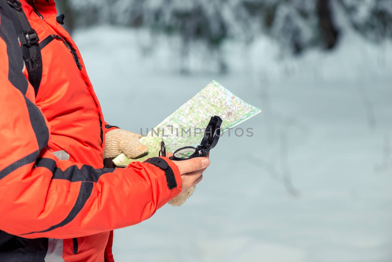 map and compass in the hands of a lost tourist in the winter for by kosmsos111