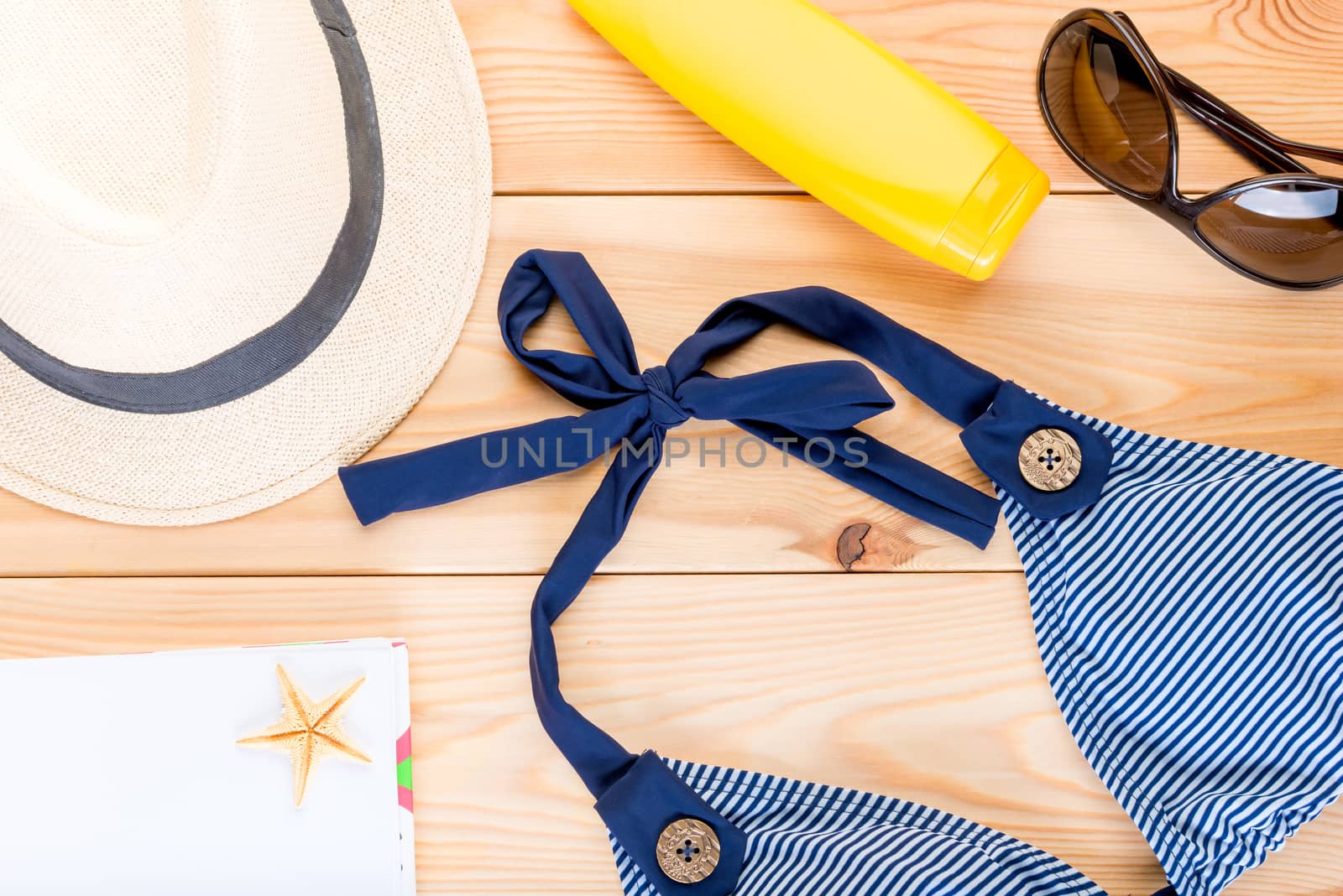 clothes and accessories for vacation near the sea view from above, objects on wooden boards