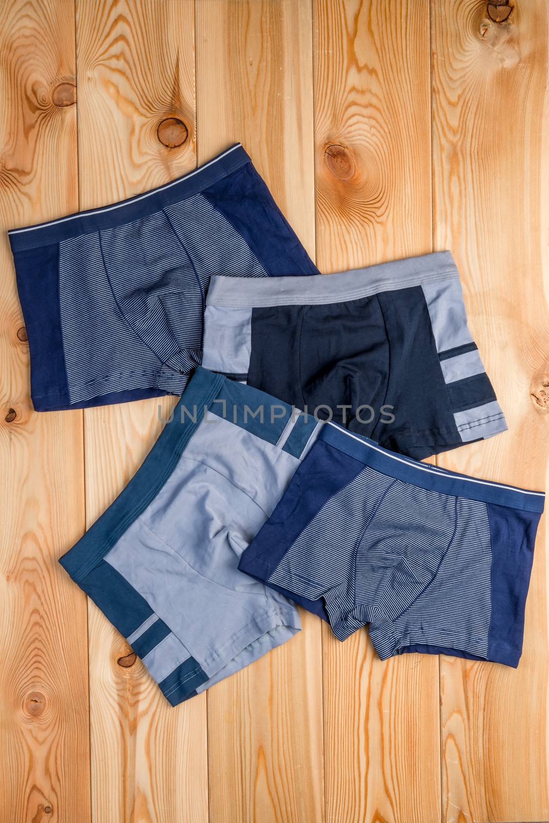 set of cotton panties for boy clothes on wooden boards top view