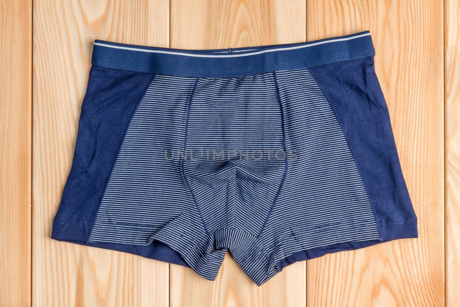 blue new cotton panties for boy clothes on wooden boards top view