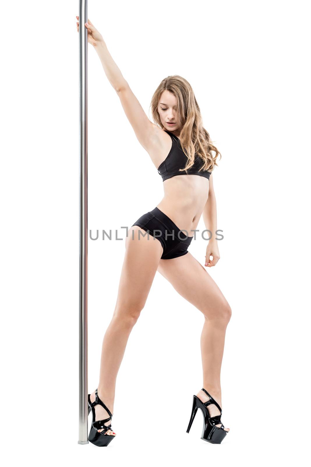 portrait of a sexy beautiful woman in lingerie and shoes at a pylon on a white background