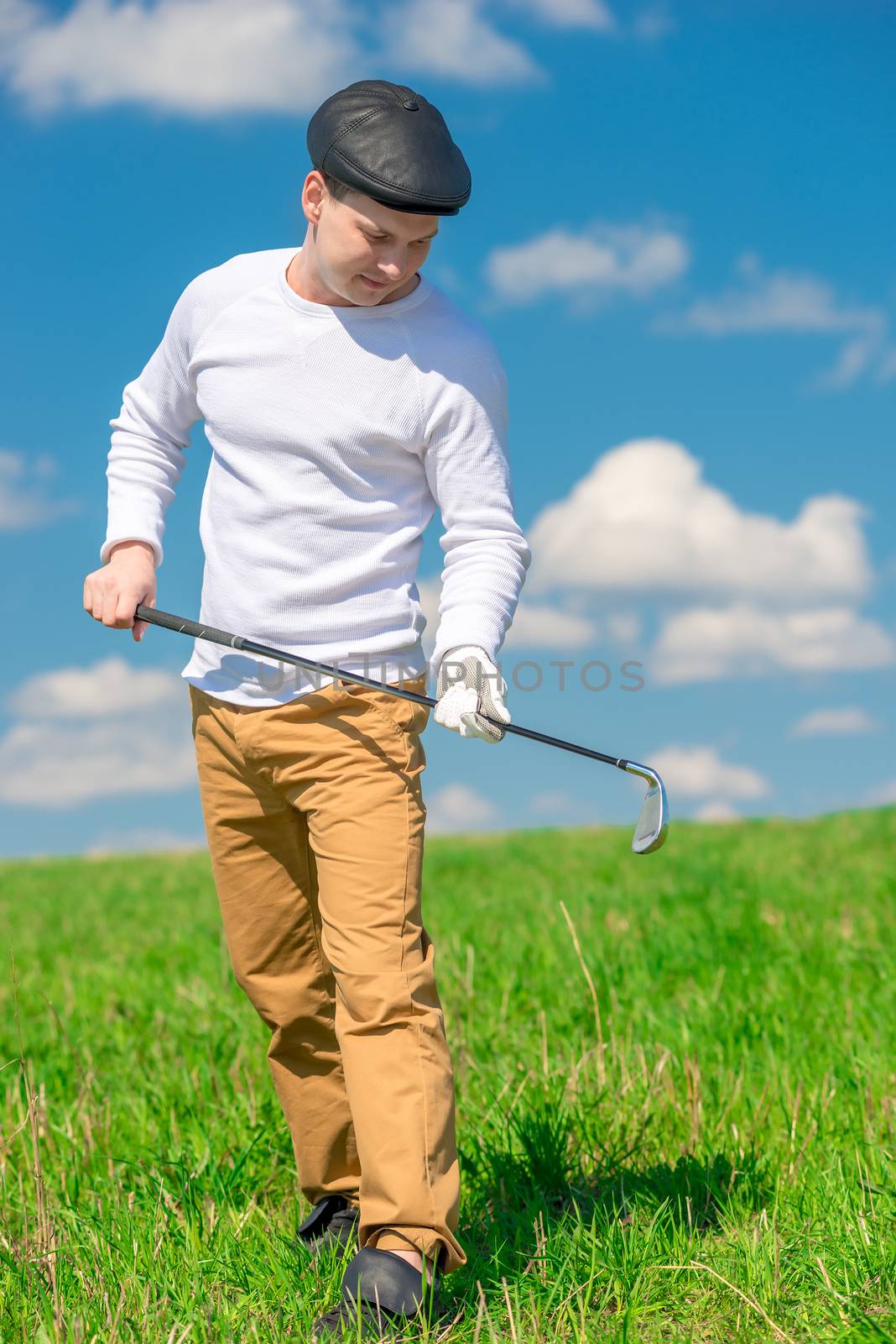 portrait of a golf player with a golf club on a sunny day on the by kosmsos111