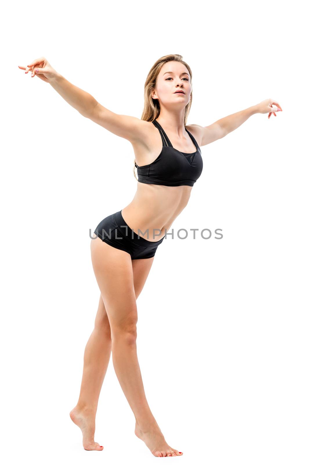 beautiful sportswoman doing relaxation exercises on white background