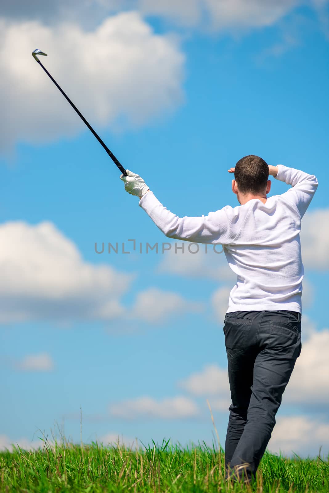 golfer watching where his ball flew to the field, view from the by kosmsos111