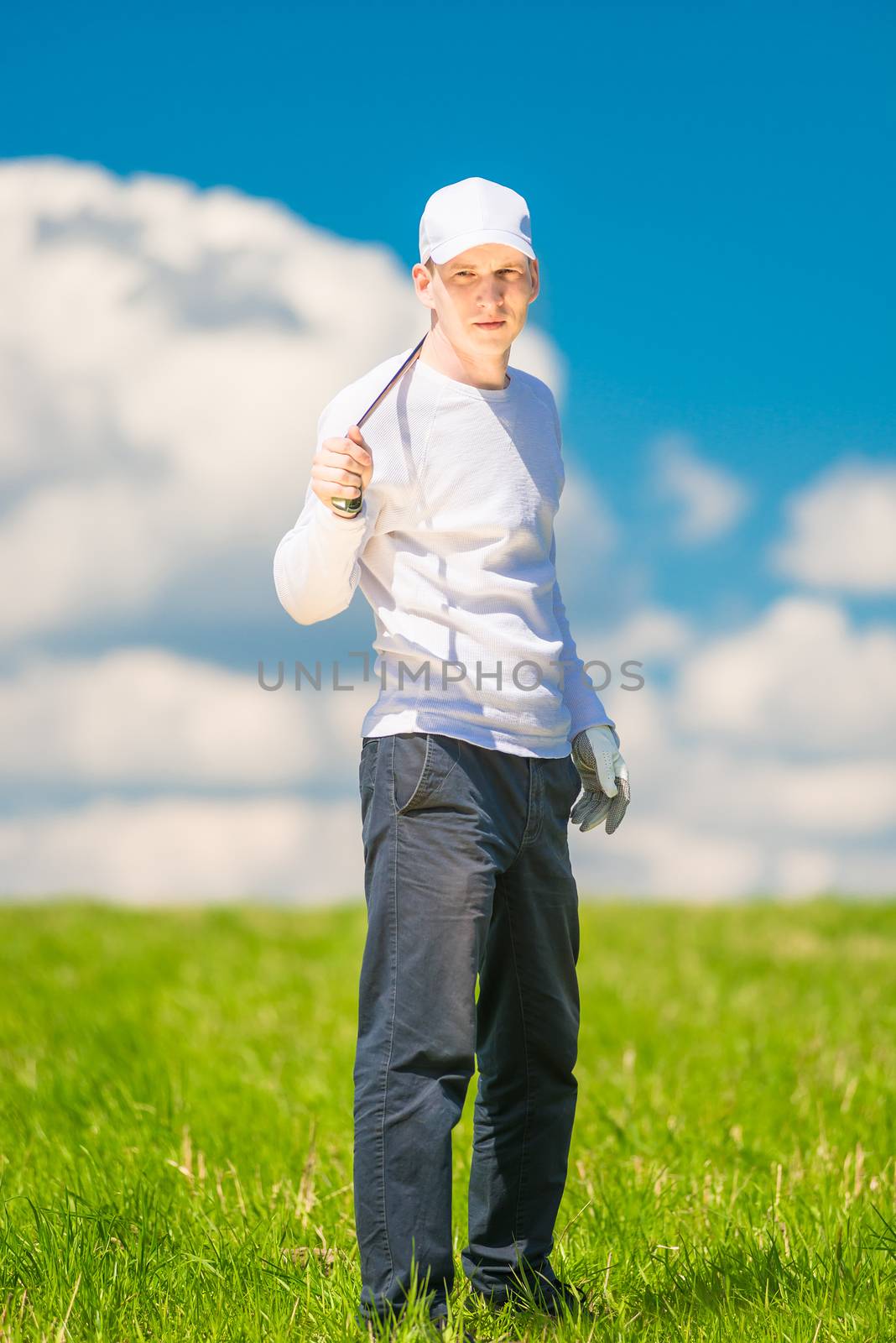 vertical portrait of a successful golfer with a golf club in the by kosmsos111