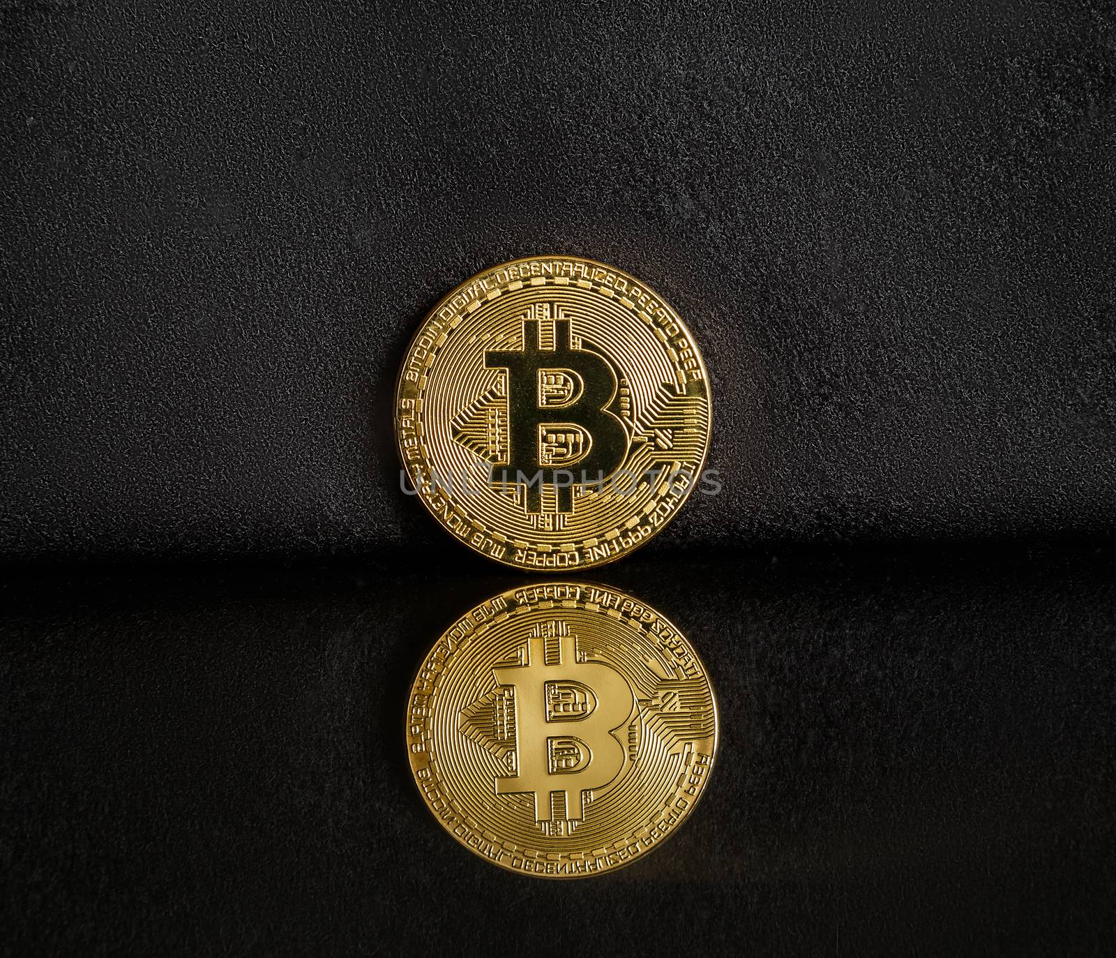 Bitcoin on a dark background with reflection