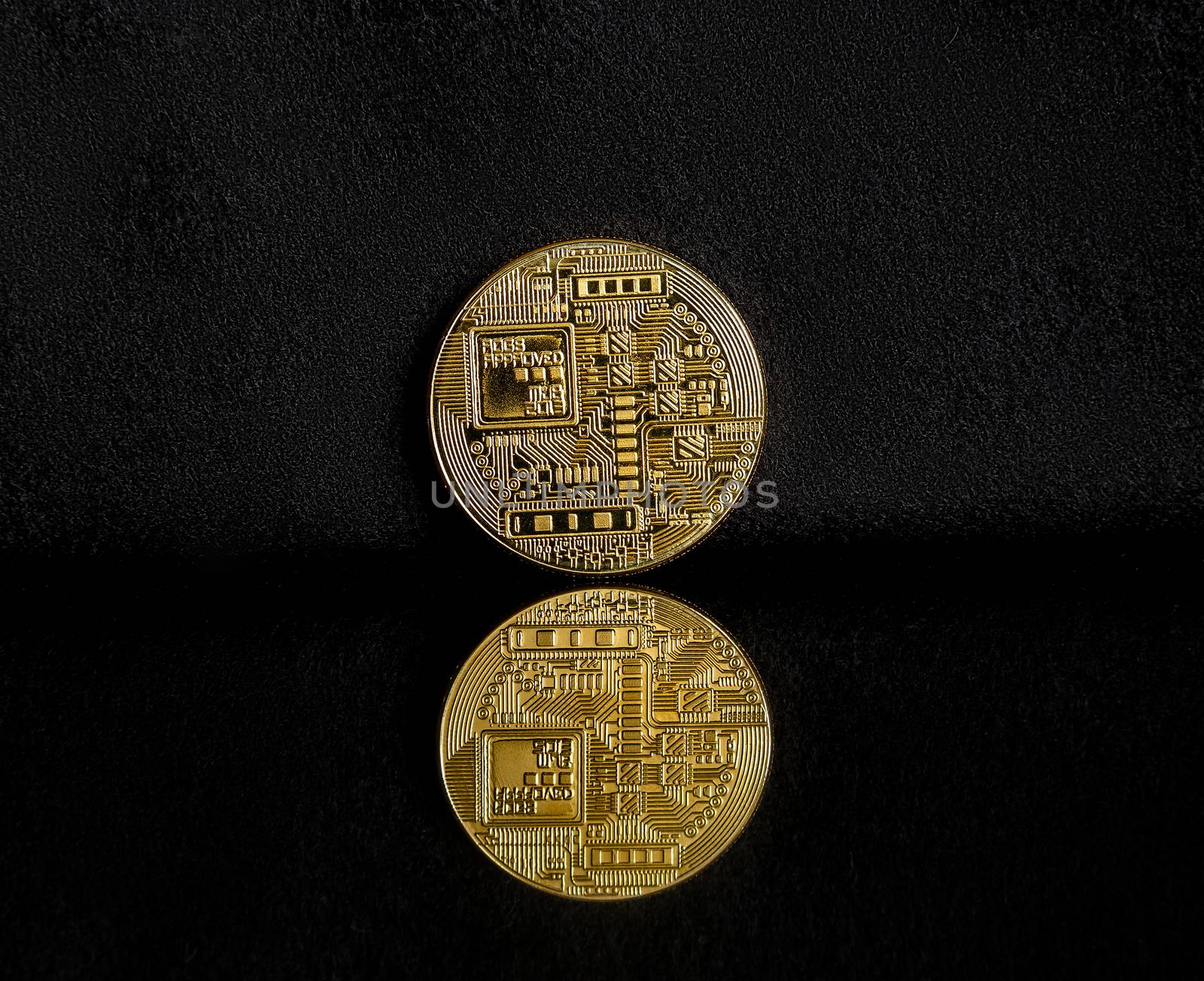 Bitcoin on a dark background with reflection