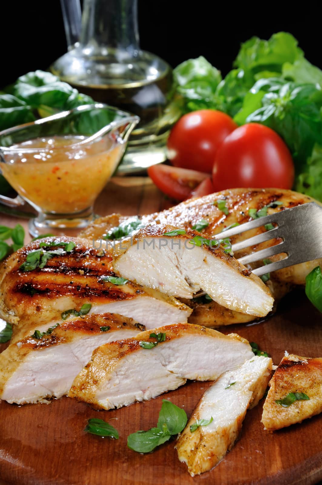 Sliced juicy, tender chicken breast grill with vegetable ingredients and dressing for a warm salad