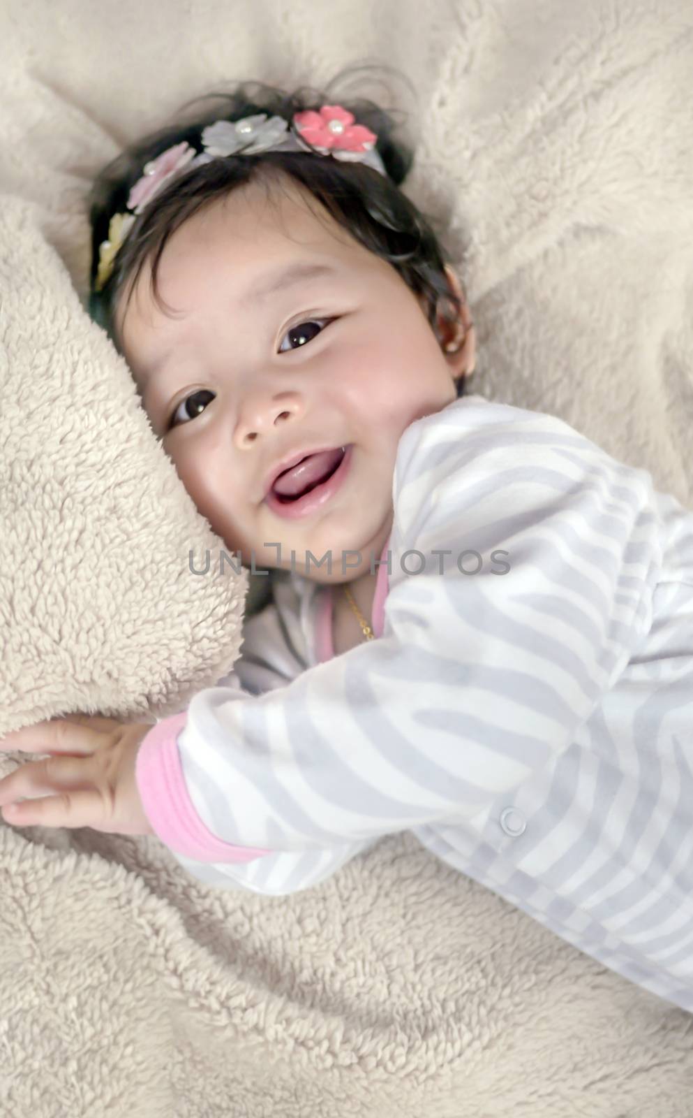 Asian cute baby girl lying on the bed