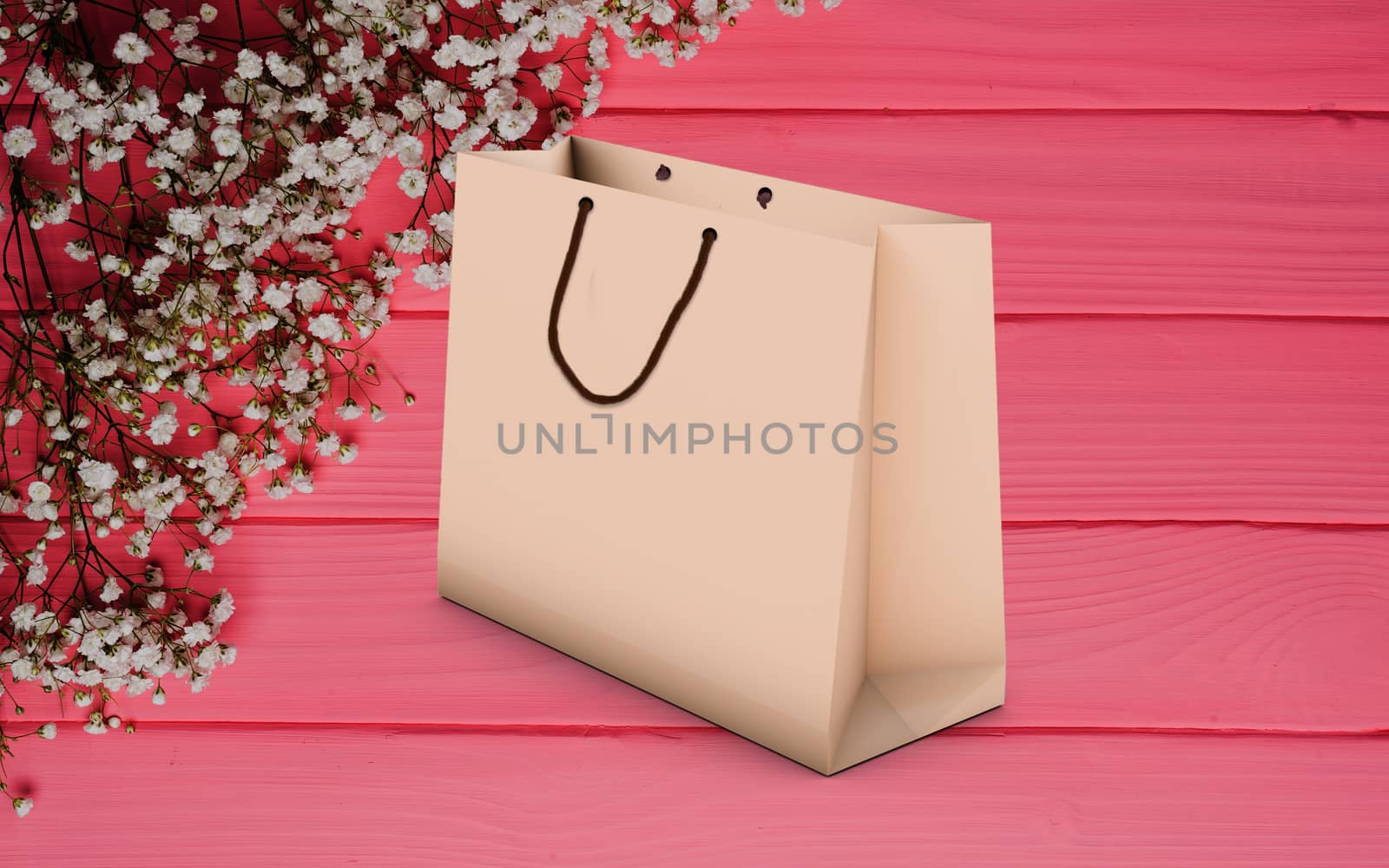 paper bag for shopping on a wooden pink background
