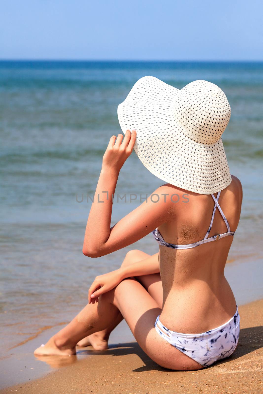 Slim woman on a beach. Summer holidays by Nobilior