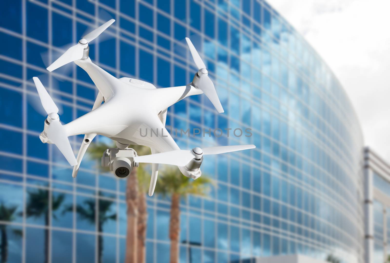 Unmanned Aircraft System (UAS) Quadcopter Drone In The Air Near Corporate Building. by Feverpitched