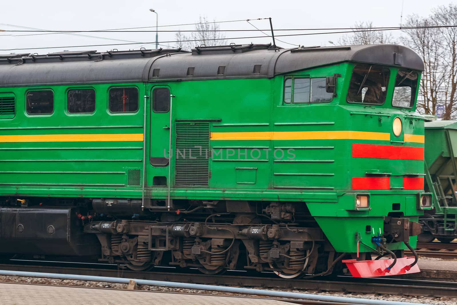 Green diesel cargo locomotive. Freight train in action