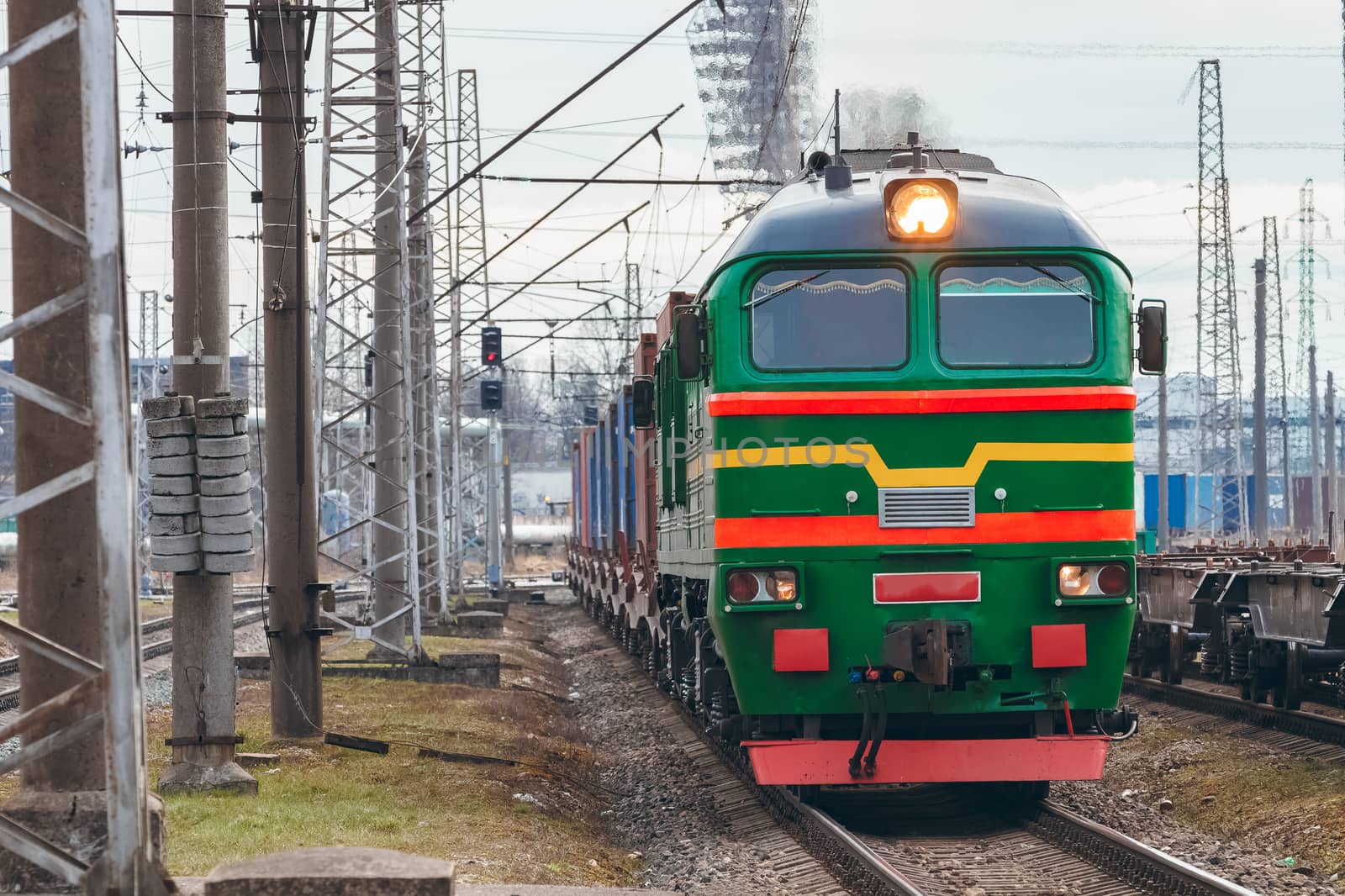 Green diesel cargo locomotive. Freight train in action