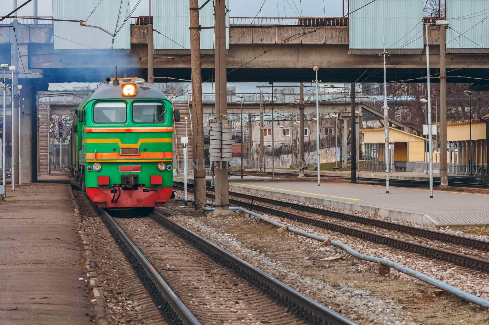 Green diesel cargo locomotive. Freight train in action