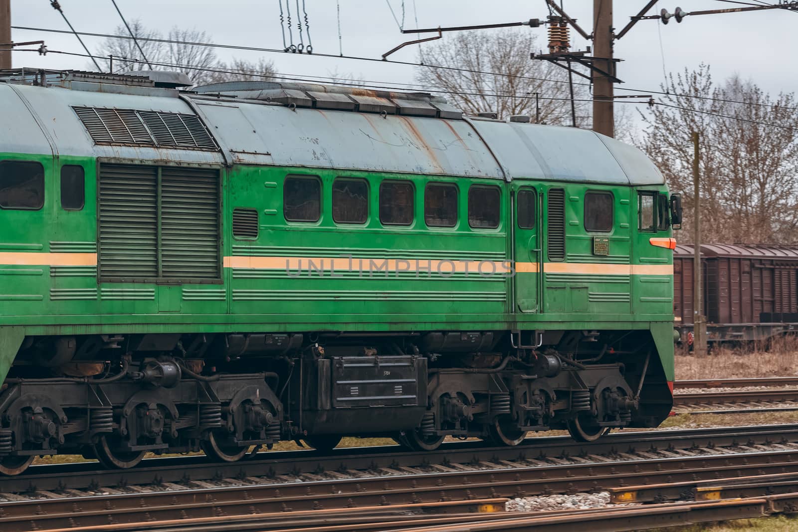 Green diesel cargo locomotive. Freight train in action