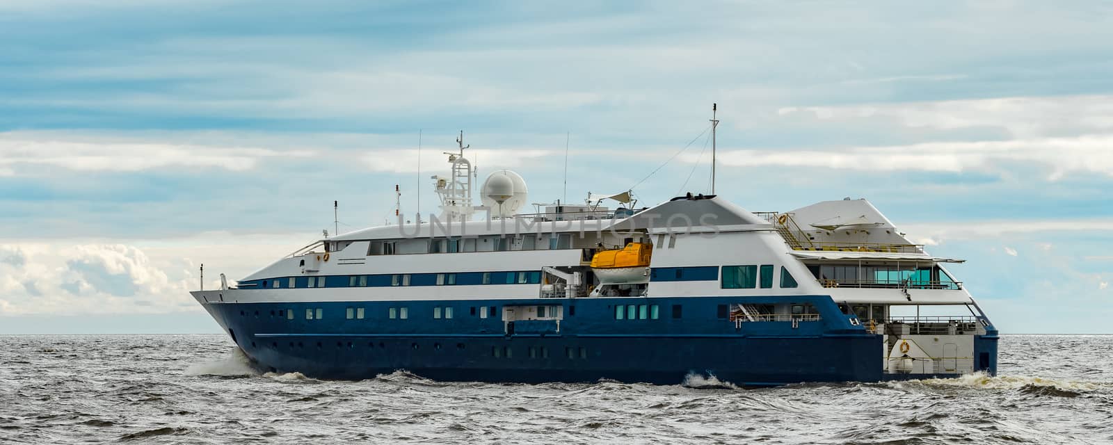 Small blue passenger ship sailing in Baltic sea. Spa services