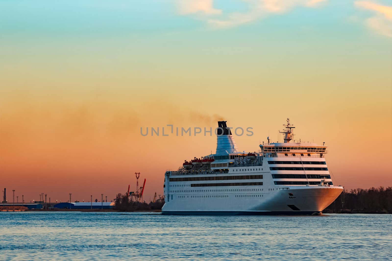 White cruise liner at sunset by sengnsp