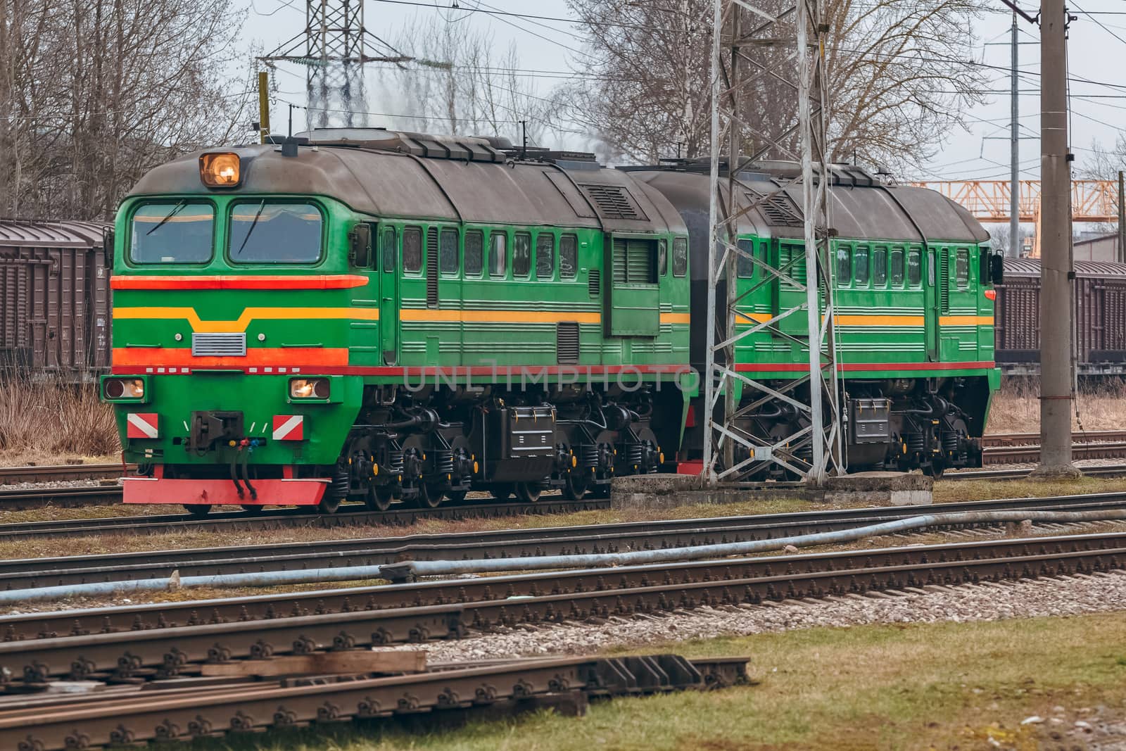 Green diesel cargo locomotive. Freight train in action