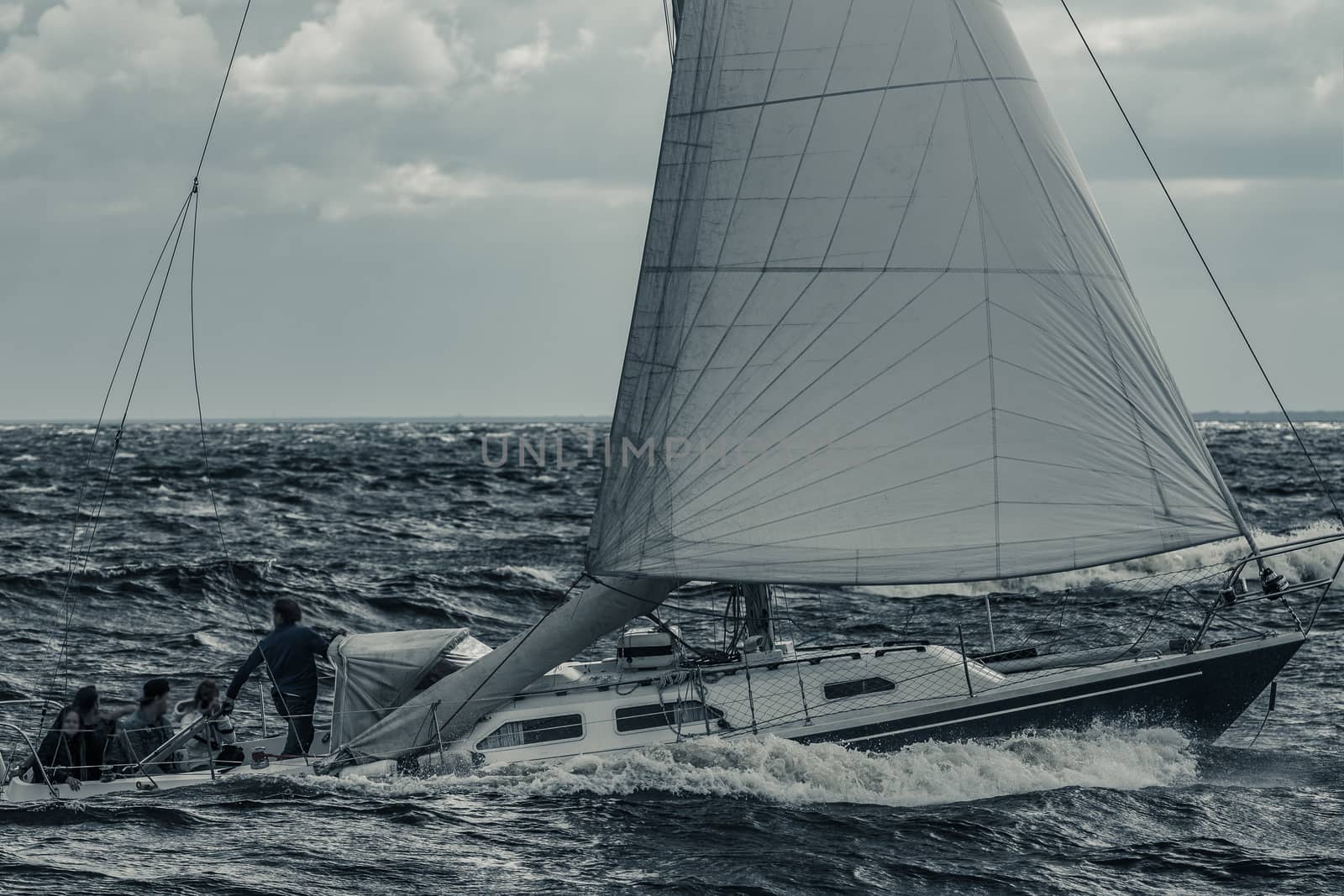 Blue sailboat at storm by sengnsp