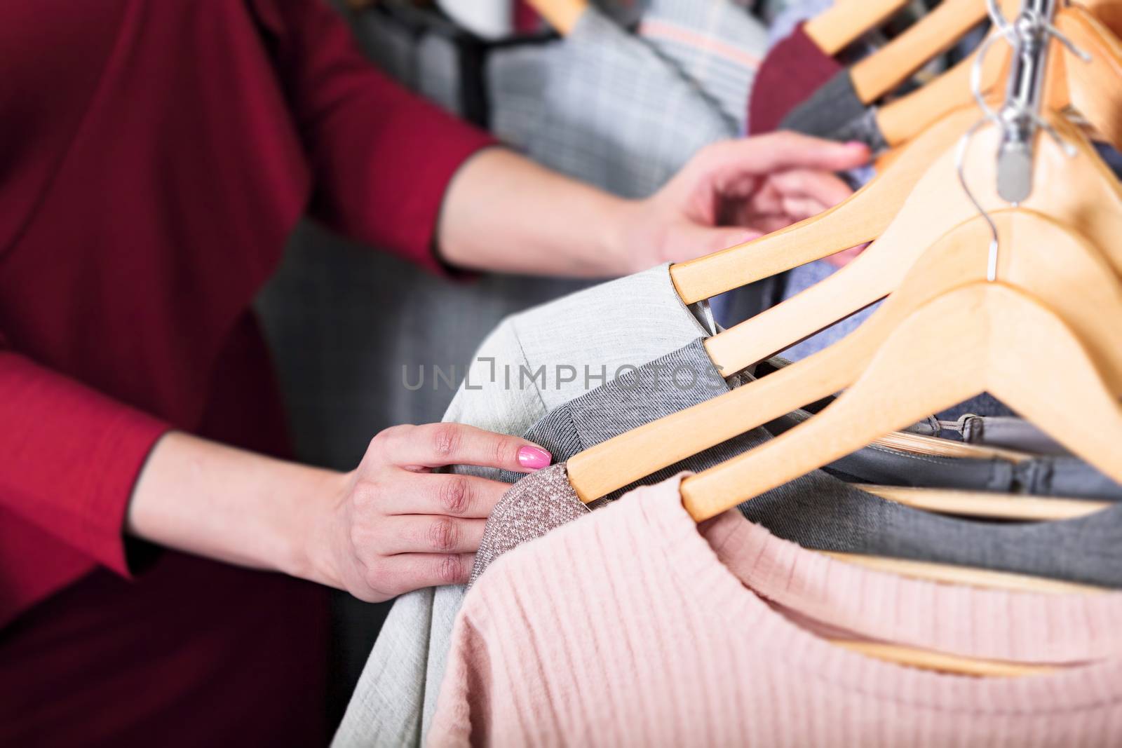 Closeup shot of hands of woman who choosing new clothes, fashion by Nobilior