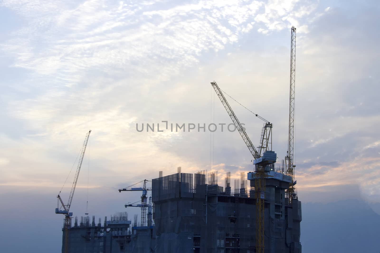 Building site with cranes and blue sky on everning