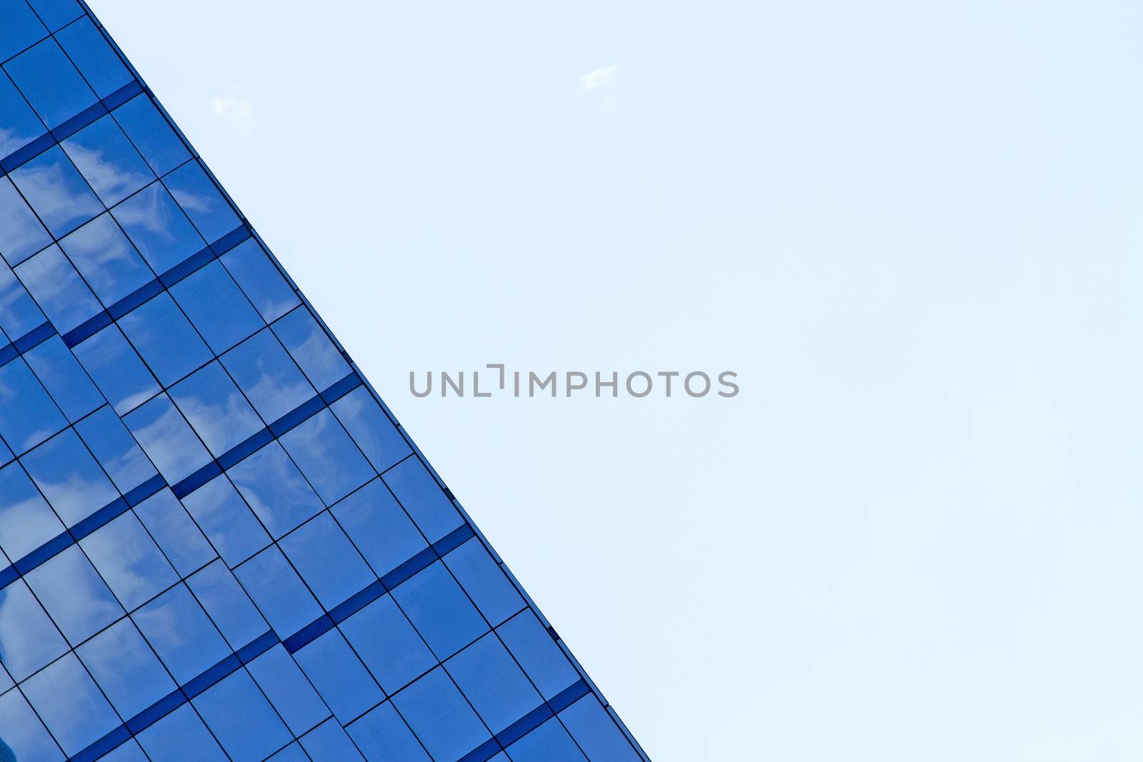 The building reflects with blue sky.