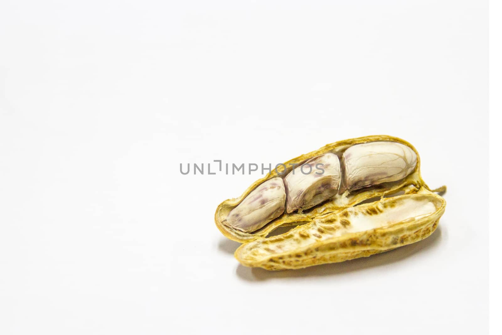 Peanuts boiled and peeled on a white background.