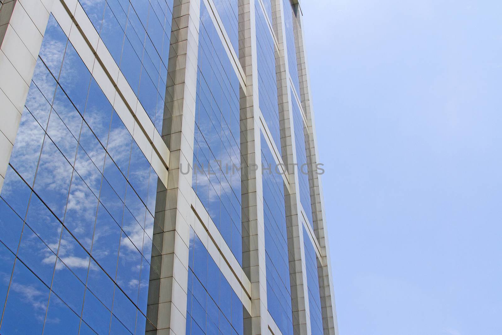 The building reflects with blue sky.