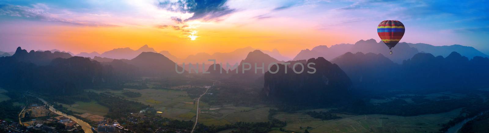 Aerial view of Vang vieng with mountains and balloon at sunset. by gutarphotoghaphy